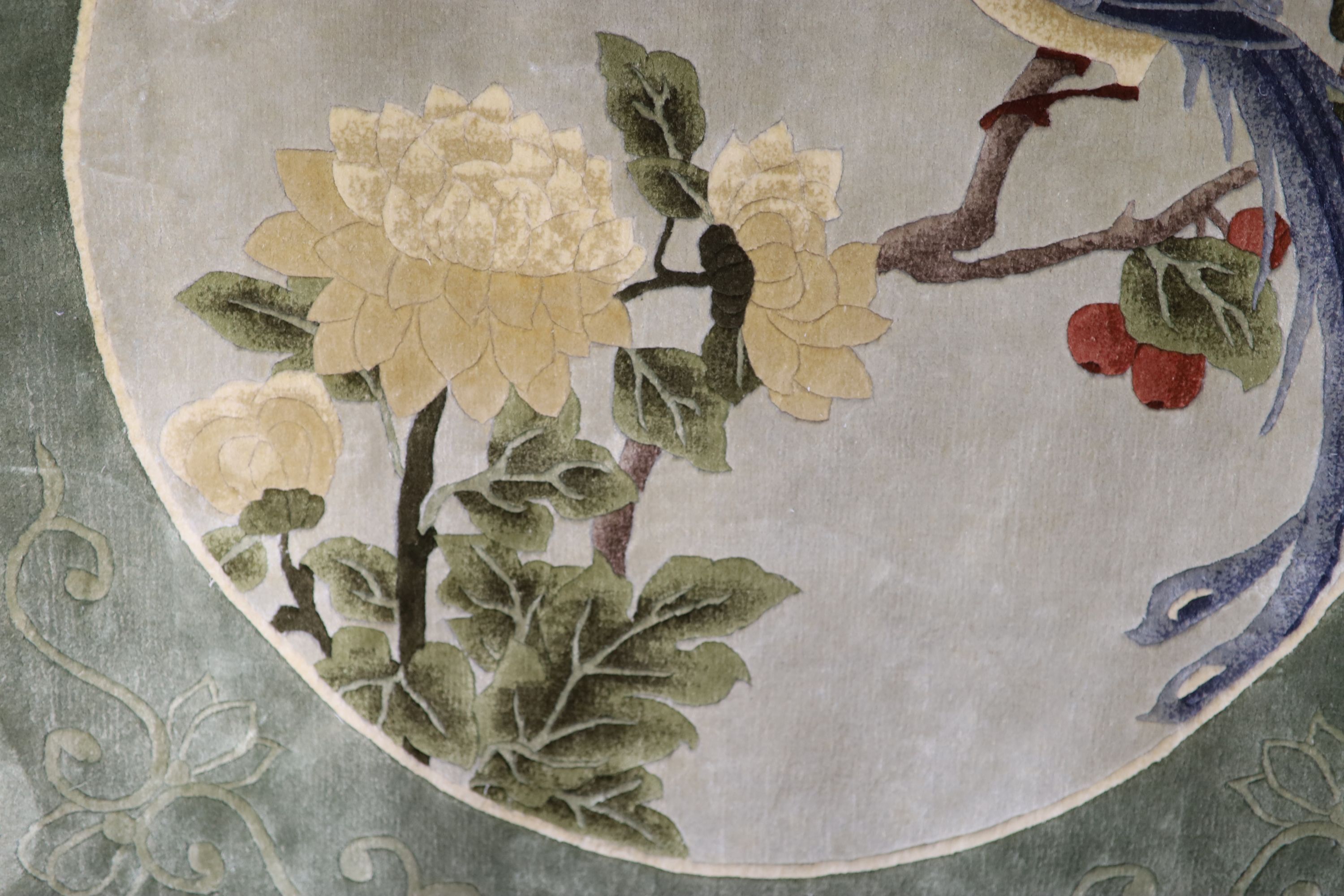 A Chinese washed and embossed panel depicting birds amongst prunus and cherries